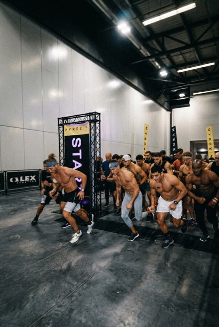 Athletes mid-workout in an industrial gym class