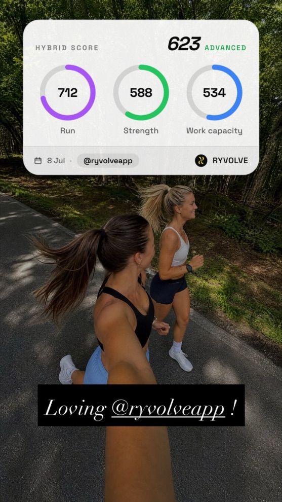 Two athletes running a forest road with a RYVOLVE Hybrid Score widget