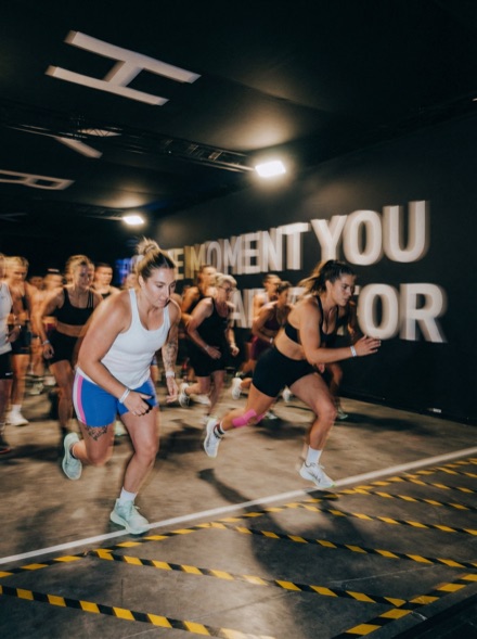 HYROX competition floor with athletes racing